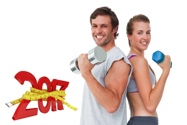 Fit couple exercising with dumbbell — Stock Photo, Image