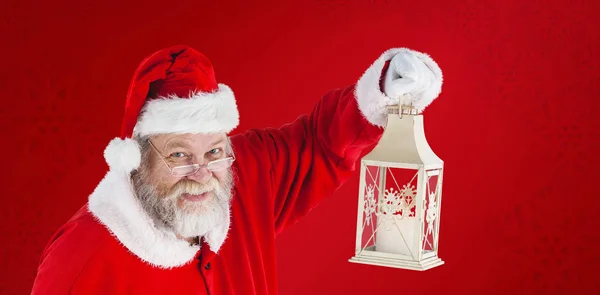 Santa Claus sosteniendo linterna de Navidad — Foto de Stock