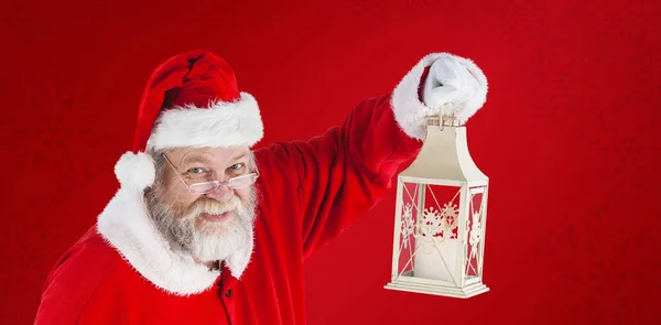 Santa Claus sosteniendo linterna de Navidad —  Fotos de Stock