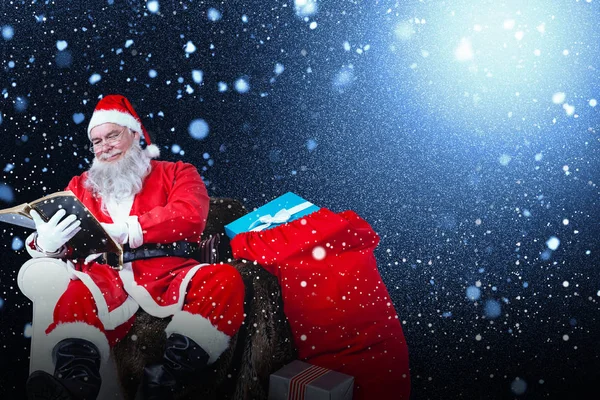 Santa reading bible — Stock Photo, Image