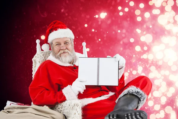 Weihnachtsmann zeigt Tagebuch — Stockfoto