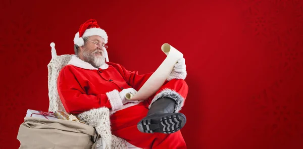 Santa claus reading wish list — Stock Photo, Image