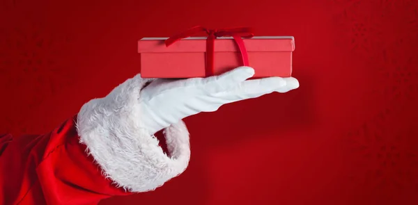 Santa sosteniendo una caja de regalo en la mano — Foto de Stock