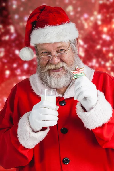 Santa holding milk and cookie — Stock Photo, Image