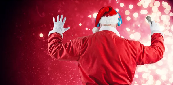 Santa claus listening to music — Stock Photo, Image