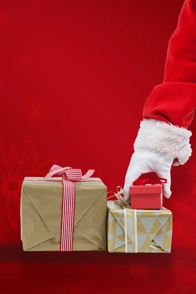 Santa claus picking christmas gift — Stock Photo, Image