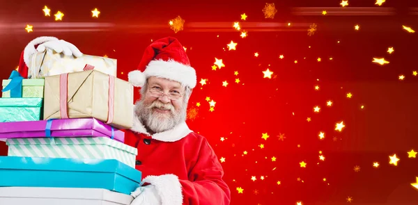 Santa claus håller jul presenterar — Stockfoto
