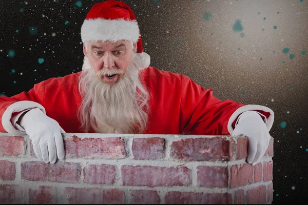 Papai Noel espreitando sobre a parede — Fotografia de Stock