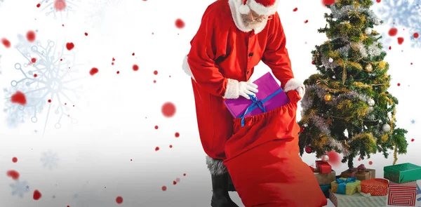 Santa claus packing christmas bag — Stock Photo, Image