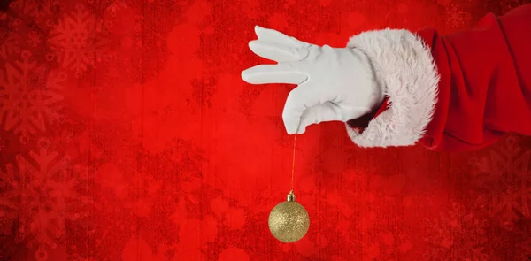 Santa claus holding christmas bauble — Stock Photo, Image