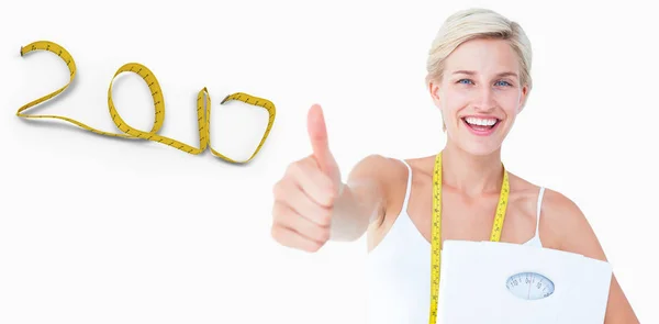 Woman holding scales with thumbs up — Stock Photo, Image