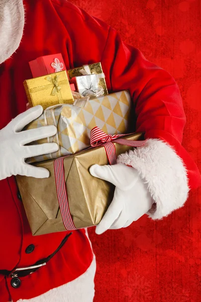 Santa claus holding presents — Stock Photo, Image