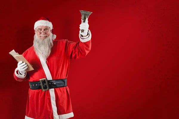 Santa claus holding bible and bell — Stock Photo, Image