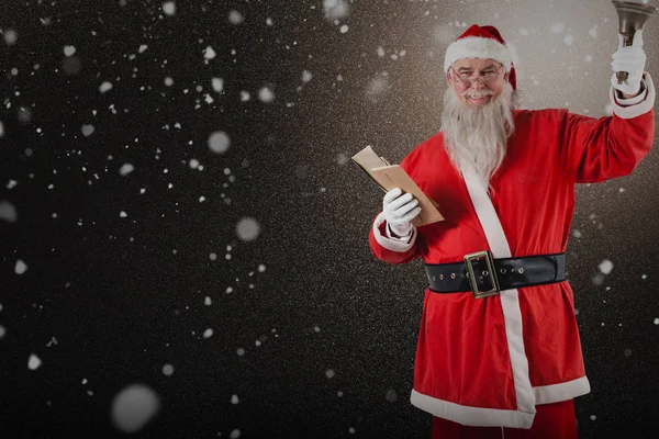 Santa claus drží bible a zvonek — Stock fotografie