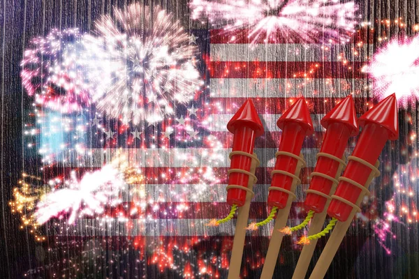 Rockets for fireworks against colourful fireworks — Stock Photo, Image
