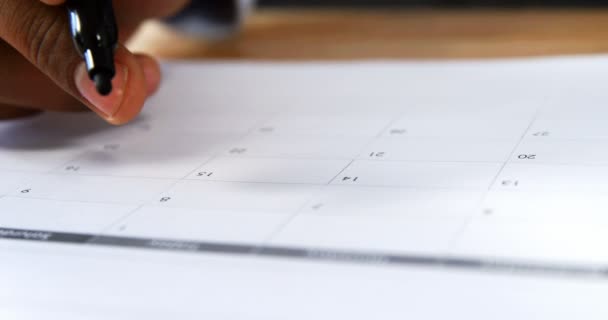 Man marking with marker pen on calendar — Stock Video