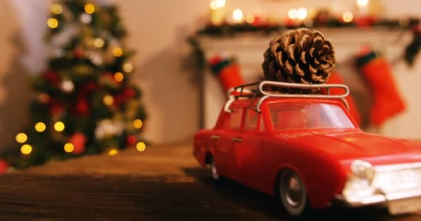 Toy car with pine cone on table — Stock Video