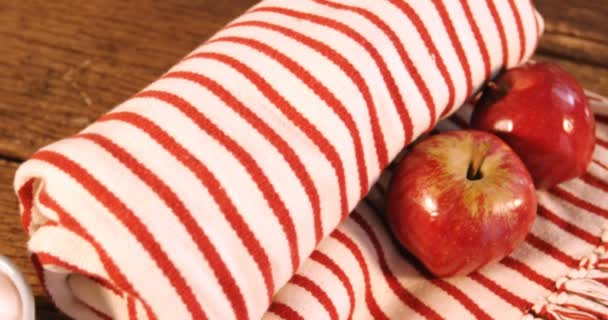 Opgerolde deken met twee appels en koffiemok — Stockvideo