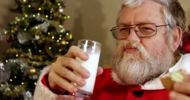 Санта-Клаус расслабляется на стуле — стоковое видео