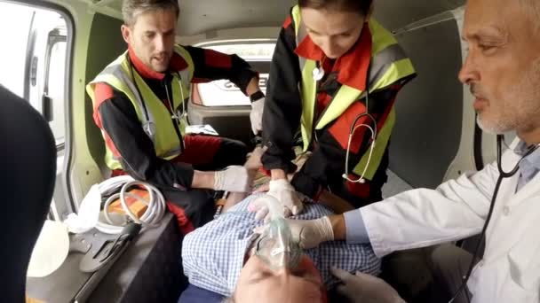 Paramedic using an external defibrillator — Stock Video