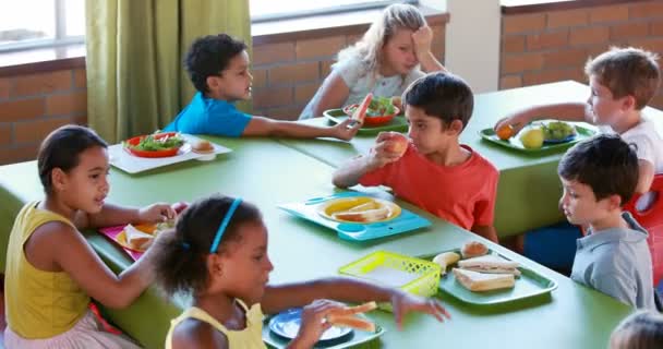 Kids having meal in cafeteria — Stock Video © Wavebreakmedia #132284248