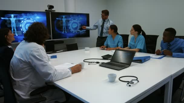 Ledande läkare som ger presentationen till team — Stockvideo