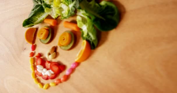 Face made up of vegetables and confectionery — Stock Video