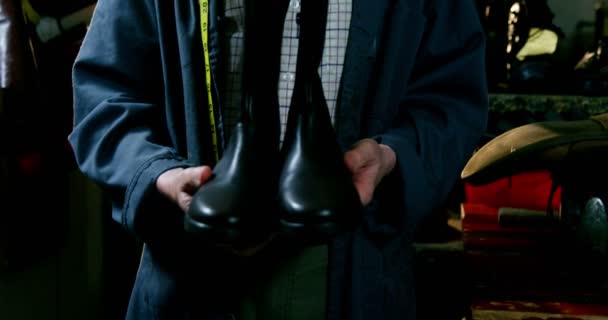 Retrato de zapatero sosteniendo una bota wellington — Vídeo de stock