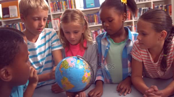 Niños estudiando sobre el globo — Vídeo de stock