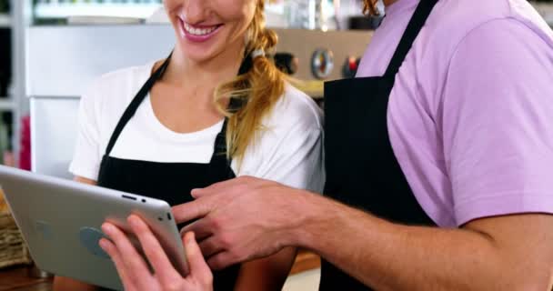 Waiter and waitress using digital tablet — Stock Video