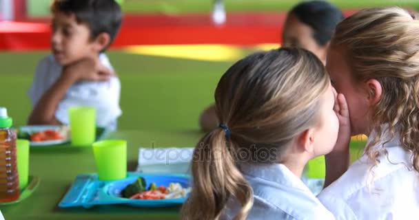 Schoolgirls whispering while having meal — Stock Video