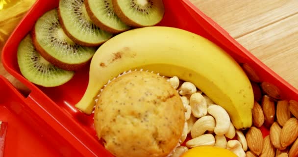 Dried fruits with banana, kiwifruit and muffin — Stock Video