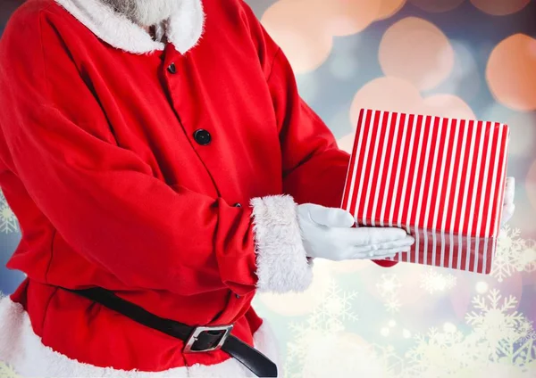 Santa claus holding a christmas gift — Stock Photo, Image