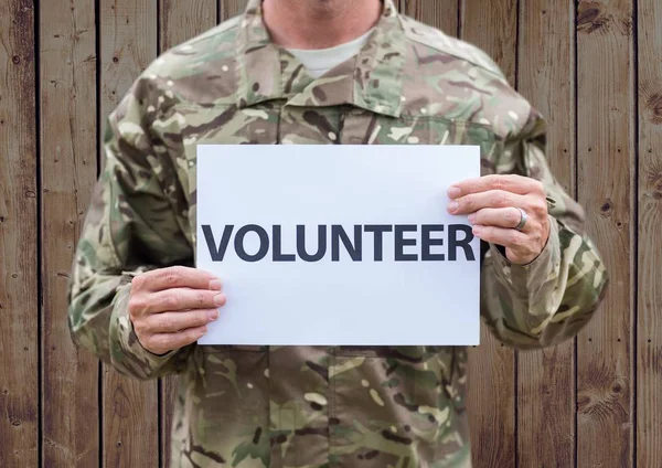 Person in camouflage uniform holding placard — Stock Photo, Image