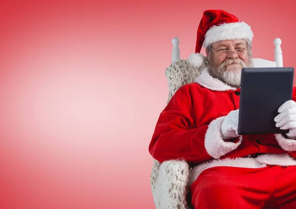 Santa claus using digital tablet — Stock Photo, Image