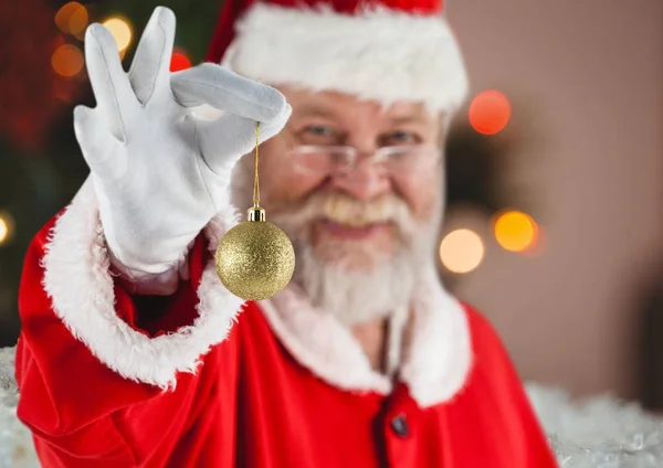 Santa holding christmas bauble — Stock Photo, Image