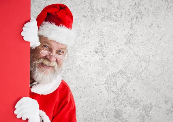 Weihnachtsmann guckt hinter Mauer — Stockfoto