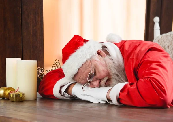 Weihnachtsmann schläft auf einem Tisch — Stockfoto