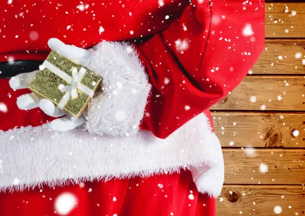 Santa hiding christmas gift behind his back — Stock Photo, Image