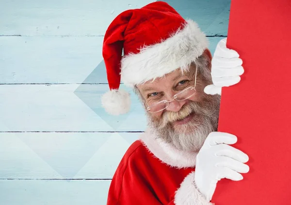 Papai Noel espreitando por trás da parede — Fotografia de Stock