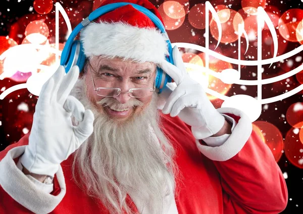 Santa Claus escuchando música auriculares —  Fotos de Stock