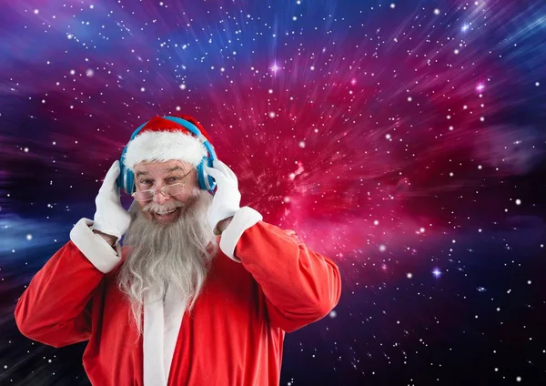 Santa claus listening music on headphones — Stock Photo, Image