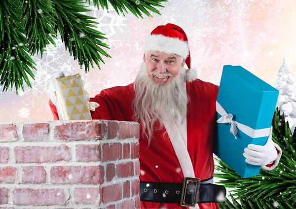 Weihnachtsmann legt Geschenke in den Schornstein — Stockfoto