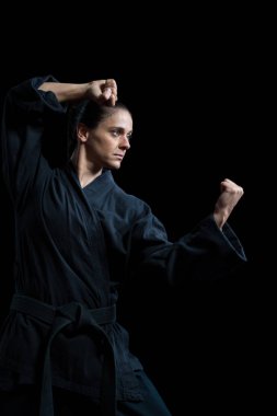 Female karate player performing karate stance clipart