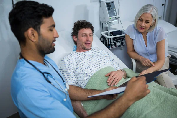 Médicos mostrando relatório médico ao paciente — Fotografia de Stock