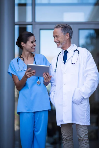 Médico y enfermera discutiendo sobre la tableta — Foto de Stock