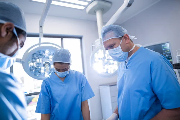 Cirurgiões realizando operação na sala de operação — Fotografia de Stock