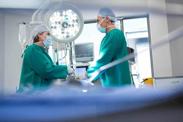 Chirurghi che interagiscono durante l'operazione del paziente — Foto Stock