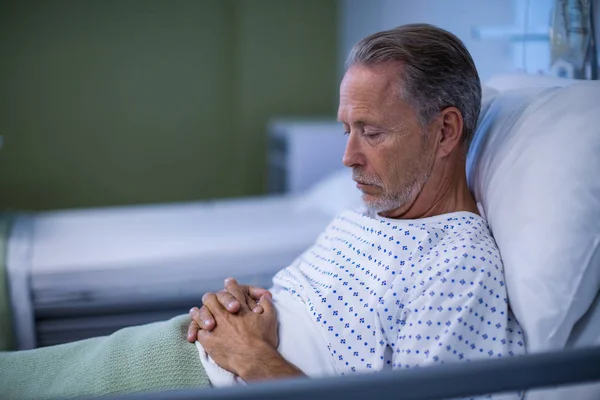 Sick patient sitting on bed — Stock Photo, Image