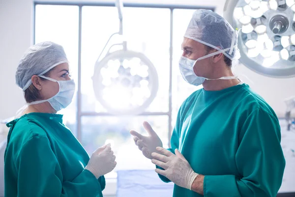 Surgeons interacting with each other — Stock Photo, Image